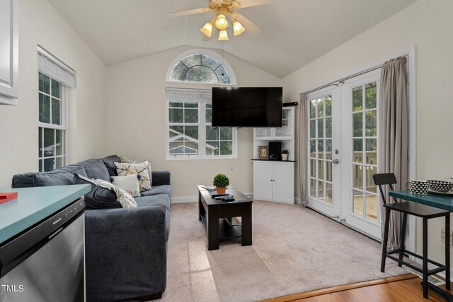 living room featuring lofted ceiling, french doors, light wood-type flooring, and ceiling fan