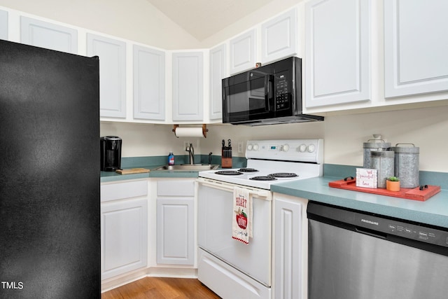 kitchen with white cabinets, sink, black appliances, light wood-type flooring, and vaulted ceiling