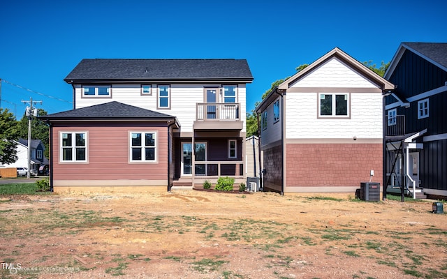 back of property featuring cooling unit and a balcony