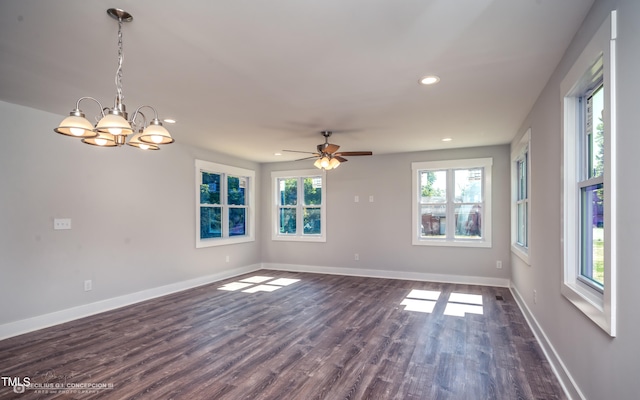 unfurnished room with ceiling fan with notable chandelier and dark wood-type flooring