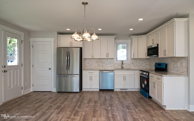 kitchen with stainless steel appliances, dark wood-type flooring, and white cabinetry