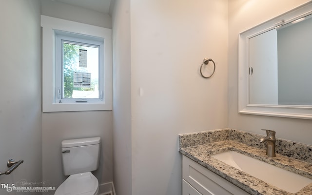 bathroom with toilet and vanity