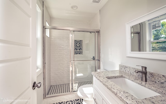 bathroom featuring walk in shower, vanity, and toilet