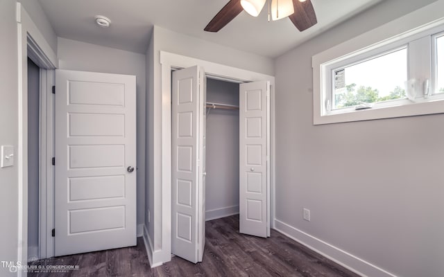 unfurnished bedroom with a closet, dark wood-type flooring, and ceiling fan