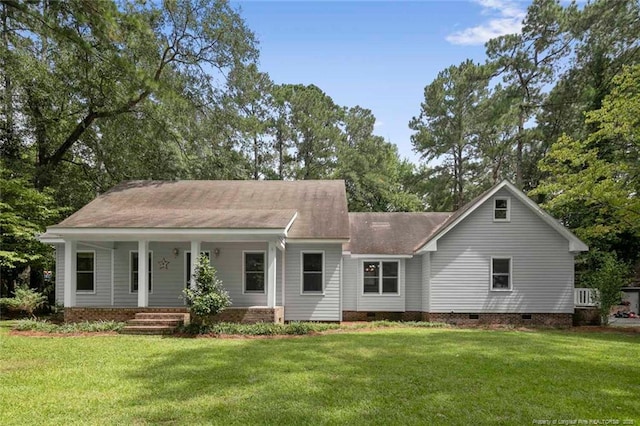 rear view of house featuring covered porch and a yard