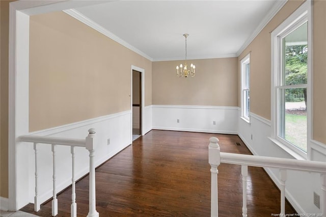 interior space featuring a wealth of natural light, crown molding, and a chandelier