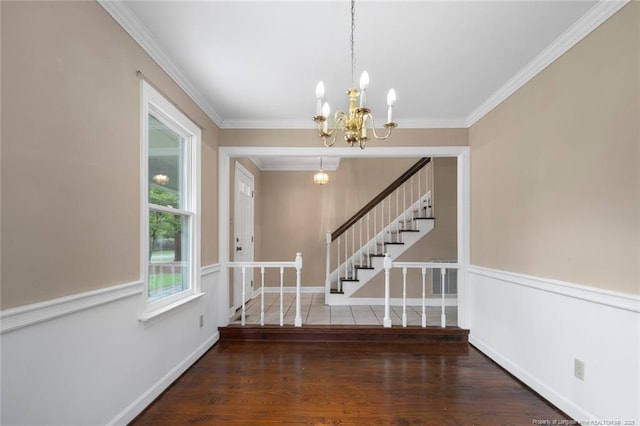 entrance foyer featuring a chandelier, dark hardwood / wood-style floors, and ornamental molding