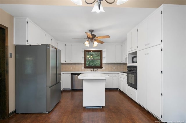 kitchen with decorative backsplash, a center island, white cabinets, and appliances with stainless steel finishes