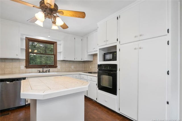 kitchen with black appliances, decorative backsplash, a center island, and white cabinets