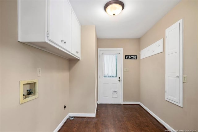 laundry area featuring cabinets, dark wood-type flooring, and hookup for a washing machine