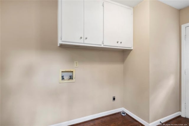 laundry area featuring hookup for an electric dryer, washer hookup, dark hardwood / wood-style flooring, and cabinets