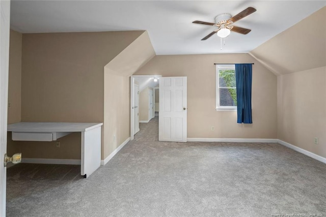 additional living space featuring ceiling fan, light carpet, and vaulted ceiling