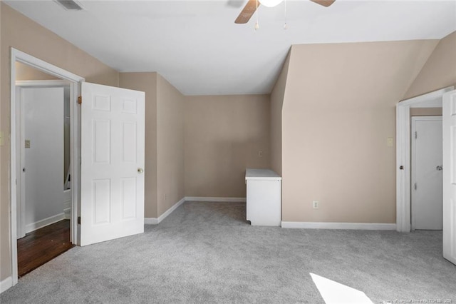 interior space featuring light carpet, ceiling fan, and lofted ceiling