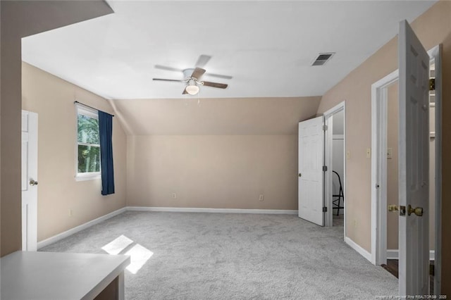 bonus room with ceiling fan, light carpet, and vaulted ceiling