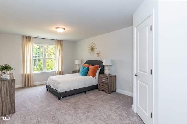 bedroom featuring light colored carpet