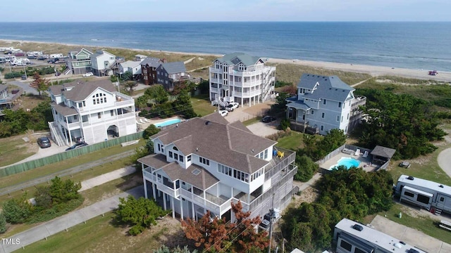 birds eye view of property with a view of the beach and a water view