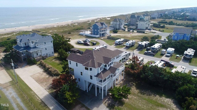 birds eye view of property featuring a water view and a view of the beach