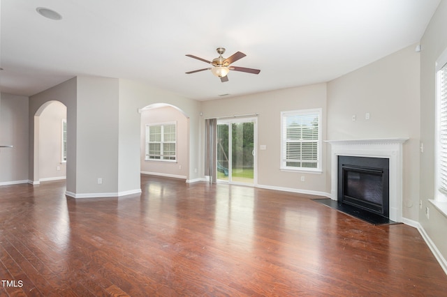 unfurnished living room with dark wood-type flooring and ceiling fan