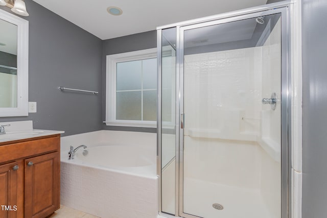 bathroom with vanity, tile patterned floors, and shower with separate bathtub