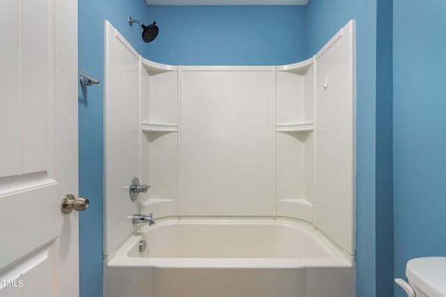 bathroom with toilet and bathing tub / shower combination