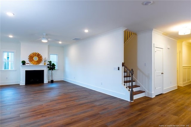 unfurnished living room featuring ceiling fan, dark hardwood / wood-style flooring, and crown molding