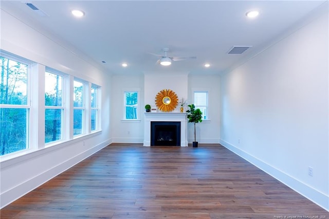 unfurnished living room featuring dark hardwood / wood-style floors and ceiling fan