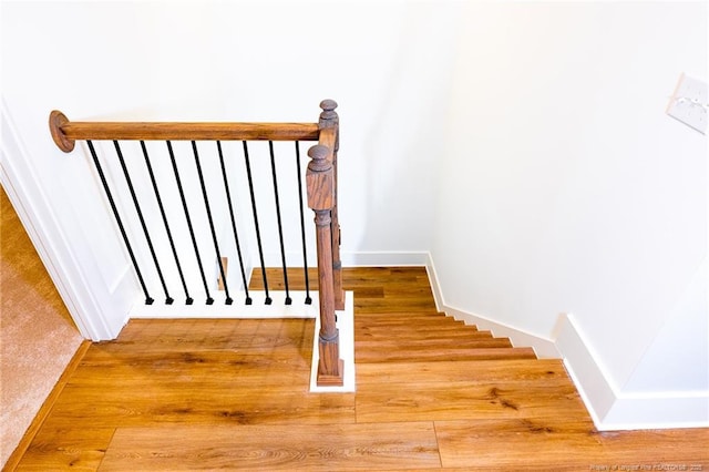 stairway featuring wood-type flooring