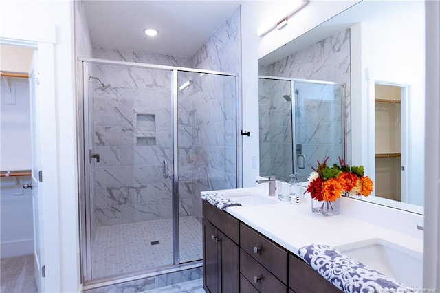 bathroom featuring vanity and an enclosed shower