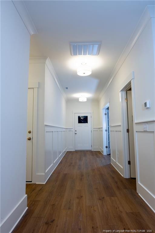 hall with dark hardwood / wood-style flooring and ornamental molding