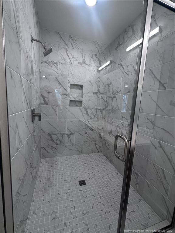 bathroom featuring an enclosed shower