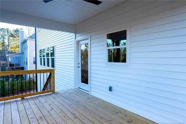 wooden deck featuring ceiling fan