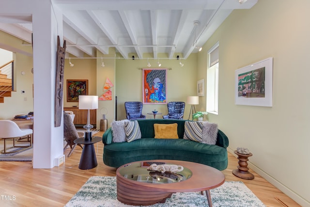 living room with beamed ceiling and wood-type flooring