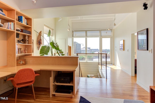 interior space featuring built in desk and light hardwood / wood-style flooring