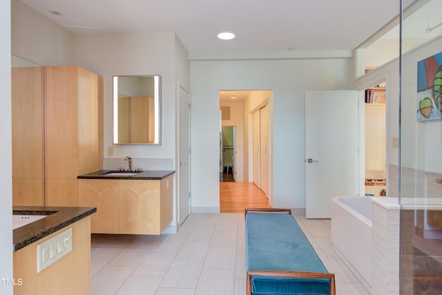 kitchen featuring sink, light hardwood / wood-style flooring, and light brown cabinets