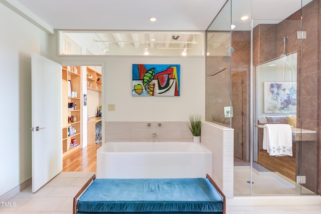 bathroom featuring tile patterned floors, shower with separate bathtub, and built in shelves