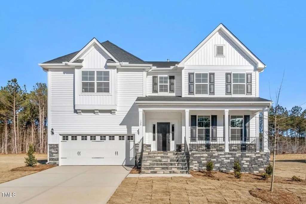 view of front facade featuring a porch, concrete driveway, board and batten siding, a garage, and stone siding