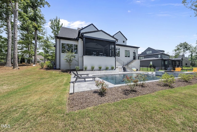 back of property with ceiling fan, a patio, a sunroom, and a yard