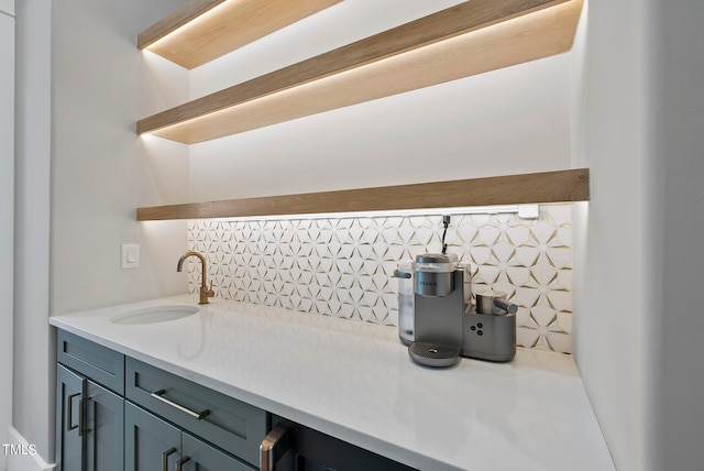 interior space with vanity and backsplash