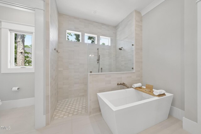 bathroom featuring tile walls, plus walk in shower, and tile patterned flooring