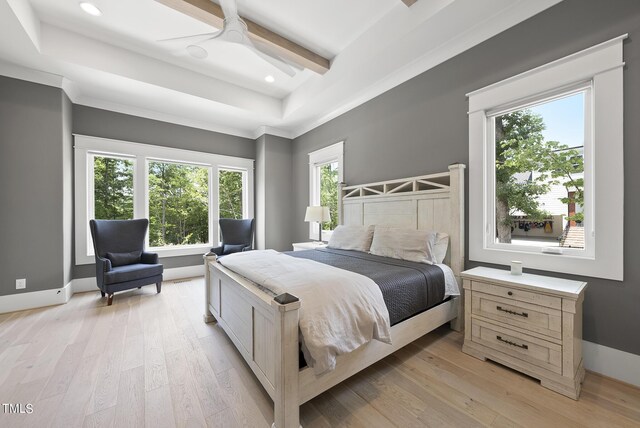 bedroom with ceiling fan, light hardwood / wood-style flooring, beamed ceiling, and a tray ceiling