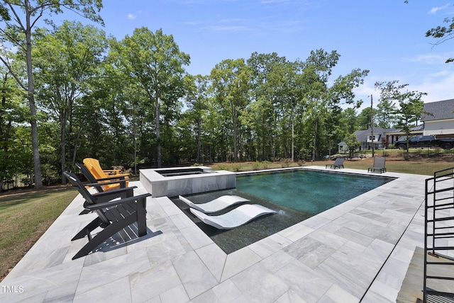 view of swimming pool with an in ground hot tub and a patio area