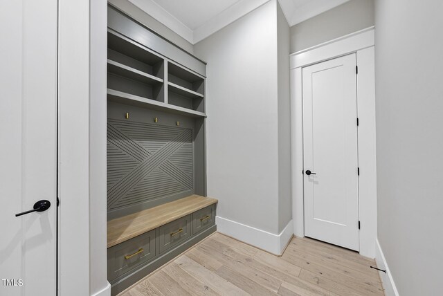 mudroom featuring light hardwood / wood-style flooring and ornamental molding