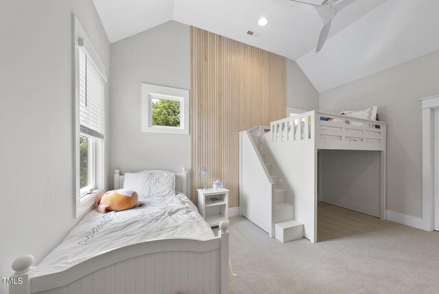 carpeted bedroom featuring ceiling fan and vaulted ceiling