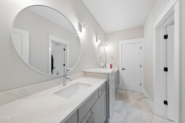 bathroom with tile patterned floors and double vanity