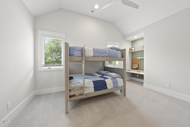 bedroom featuring ceiling fan, light colored carpet, and lofted ceiling