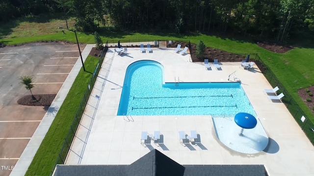 view of pool featuring a patio and a lawn