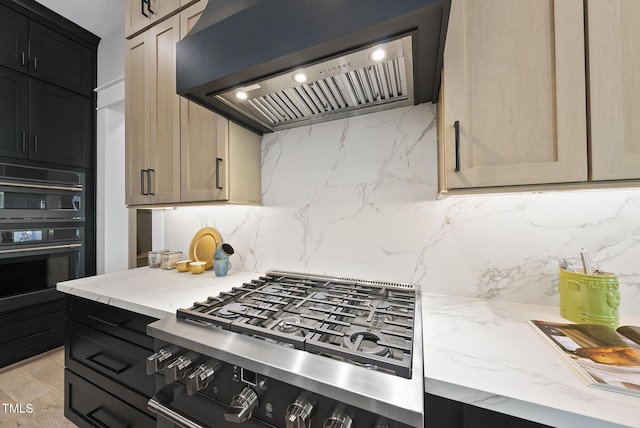 kitchen featuring stovetop, light stone countertops, wall chimney exhaust hood, and decorative backsplash
