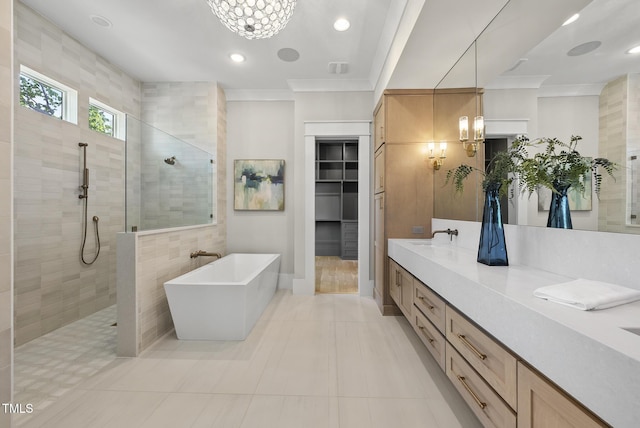 full bath with a chandelier, double vanity, a soaking tub, and a walk in shower