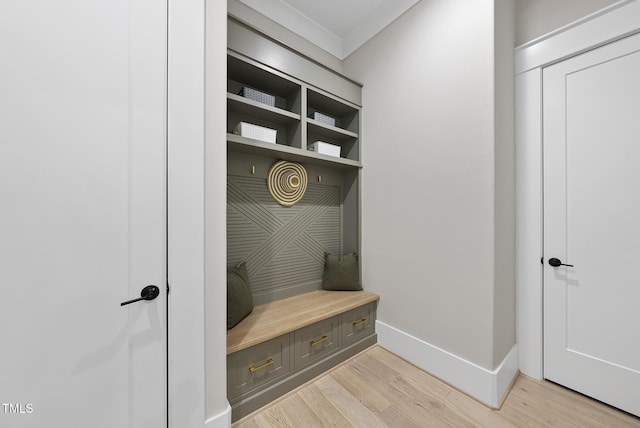 mudroom featuring light wood-style flooring, baseboards, and ornamental molding