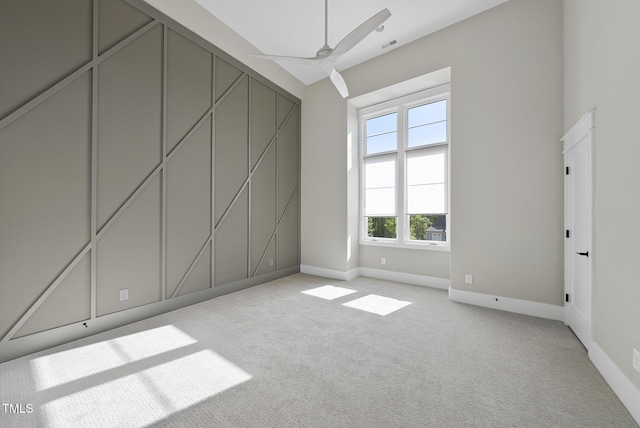 unfurnished room featuring visible vents, a ceiling fan, baseboards, and light colored carpet